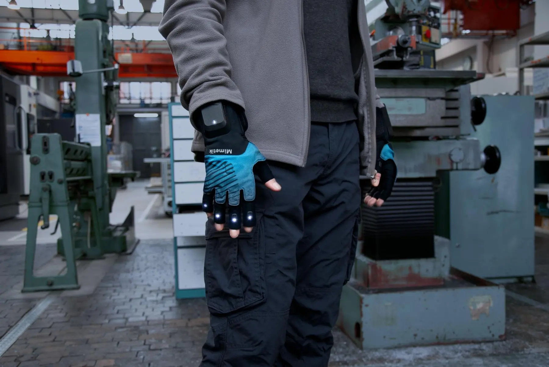 Worker wearing Mimetik smart gloves on an industrial shopfloor